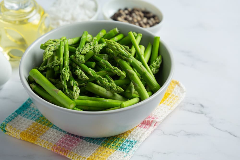 Fresh green asparagus in bowl