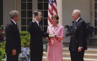 Kavanaugh is sworn into the D.C. Circuit by Justice Anthony Kennedy as his wife holds the Bible and President Bush looks on, 2006