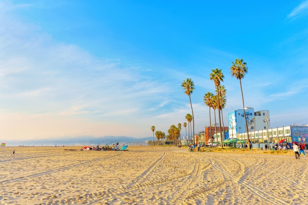 Los Angeles, CA - December 29, 2022. Sunny Winter Day at Venice Beach. People Walking and Cycling. By Shutterstock.com - Chizhevskaya Ekaterina