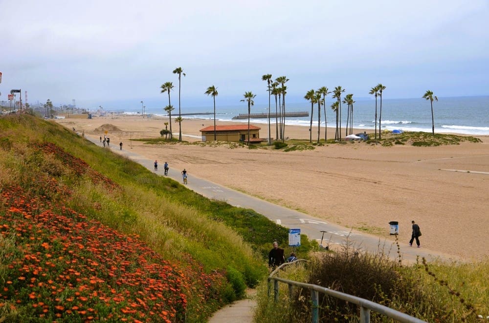 Los Angeles, CA, Dockweiler State Beach, May 22 2023. The ocean at sunset on the shore concrete bike path. By Shutterstock.com - Julia56