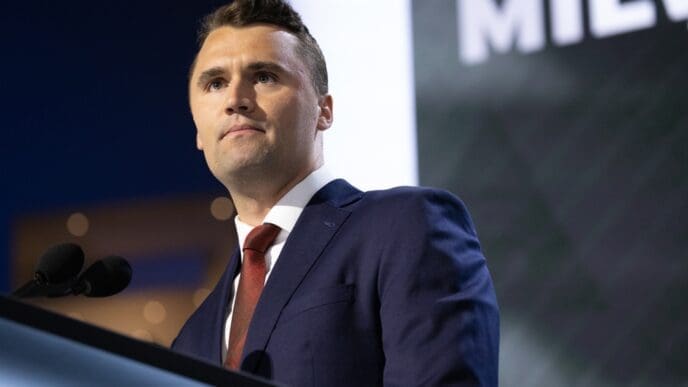 Turning Point USA CEO Charlie Kirk looks out at the audience while speaking at a podium