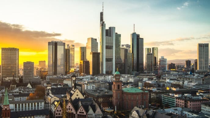 The cityscape of Frankfurt's financial district is adorned with modern buildings at sunset