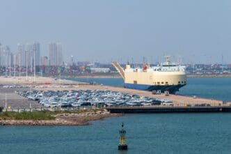 Tiangin, China - 08.20.2022. New cars waiting in a port Tianjin, China. By Shutterstock - ambient_pix