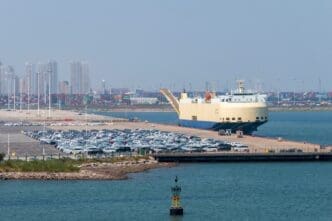 Tiangin, China - 08.20.2022. New cars waiting in a port Tianjin, China. By Shutterstock - ambient_pix