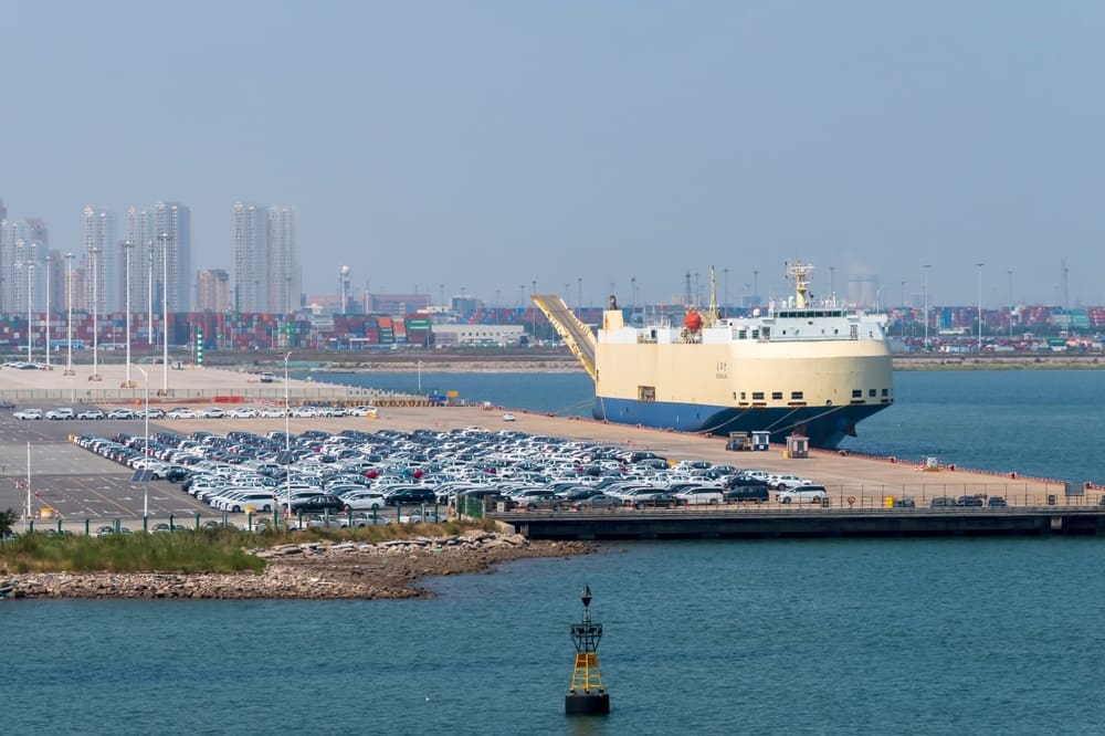 Tiangin, China - 08.20.2022. New cars waiting in a port Tianjin, China. By Shutterstock - ambient_pix