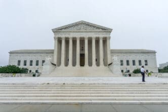Washington, DC. A Supreme Court policeman walks in front of the US Supreme Court as protests are expected during the confirmation process of Brett Kavanaugh. By Shutterstock - Erik Cox Photography