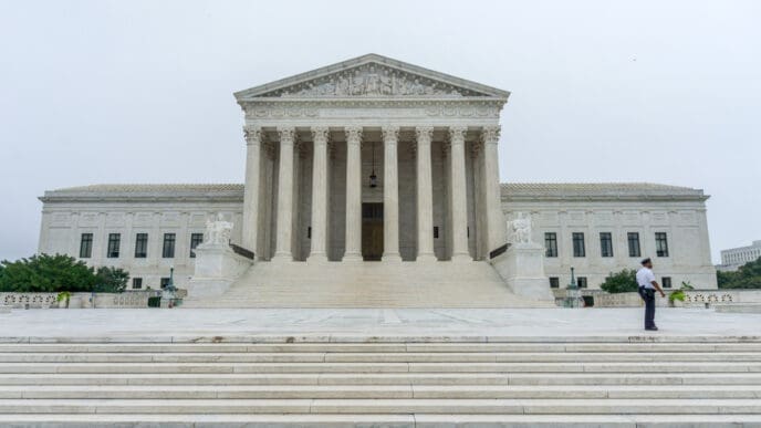 Washington, DC. A Supreme Court policeman walks in front of the US Supreme Court as protests are expected during the confirmation process of Brett Kavanaugh. By Shutterstock - Erik Cox Photography