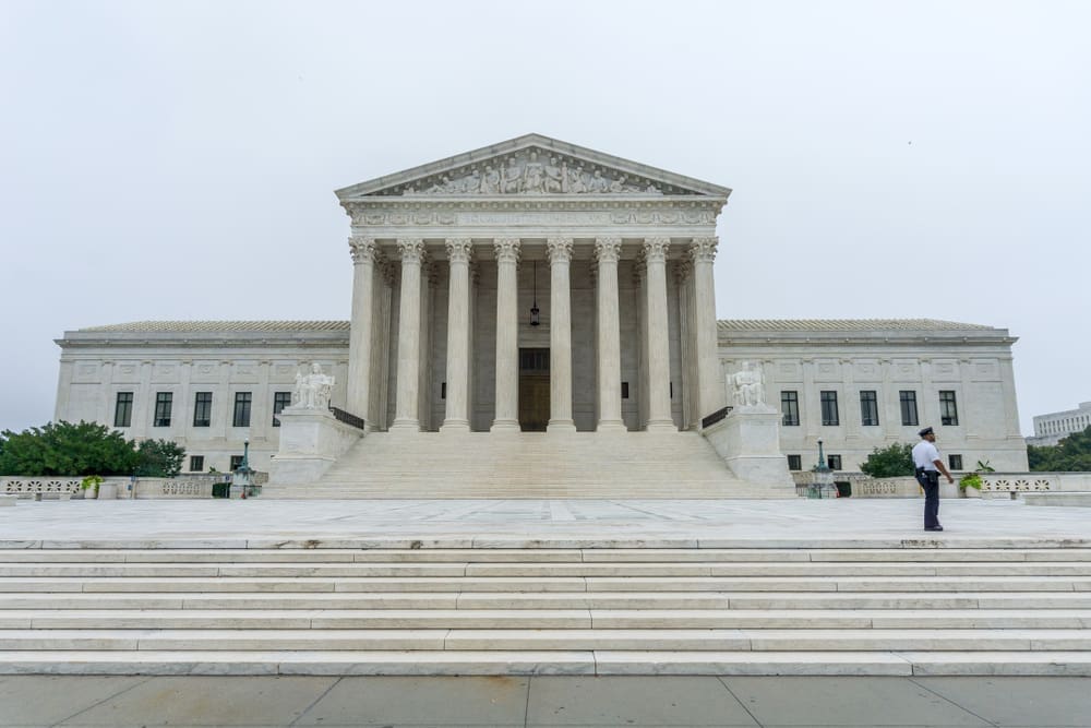 Washington, DC. A Supreme Court policeman walks in front of the US Supreme Court as protests are expected during the confirmation process of Brett Kavanaugh. By Shutterstock - Erik Cox Photography
