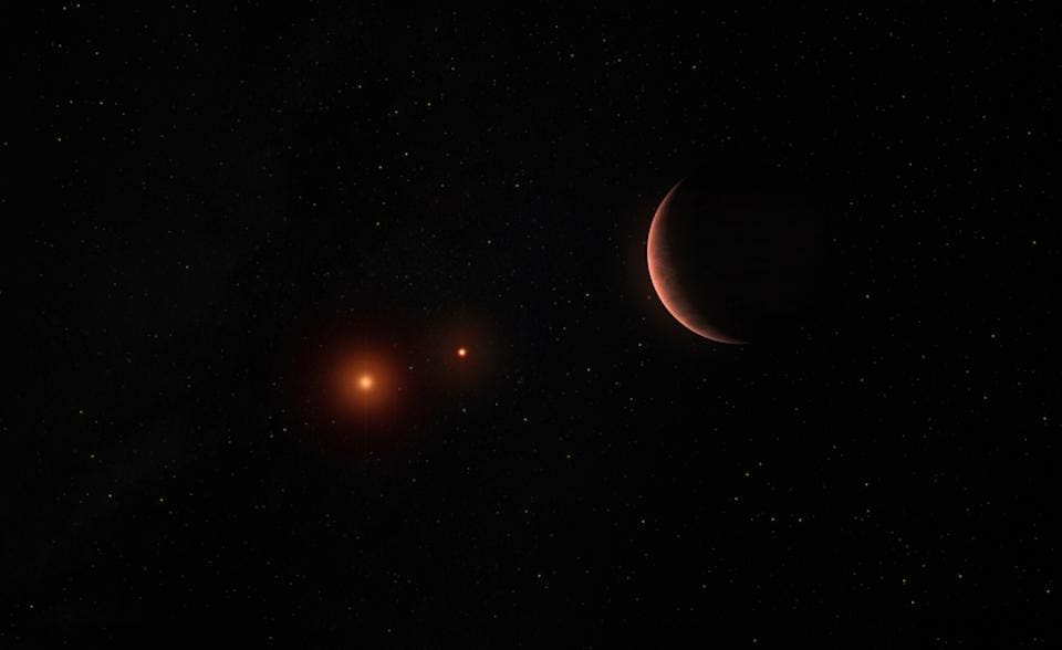 This illustration by the European Southern Observatory depicts an exoplanet orbiting two brown dwarfs, celestial objects that are lighter than stars but heavier than gas giant planets.