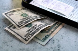 Venice Beach, Los Angeles, California / USA - 06/23/2007: Paying the bill at a dinner. Dollar tip. $ 40 as a restaurant bill