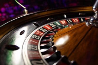 Casino roulette wheel close up ready to play and waiting for bets.