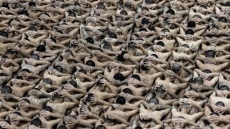 Detainees stand in formation before being escorted to their cells at a high-security facility in Tecoluca, El Salvador.