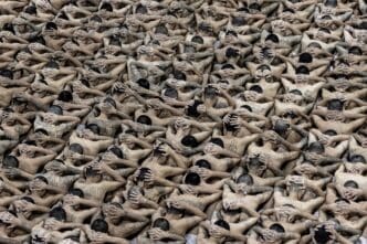 Detainees stand in formation before being escorted to their cells at a high-security facility in Tecoluca, El Salvador.
