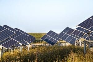 A solar power station's photovoltaic panels set against a natural background
