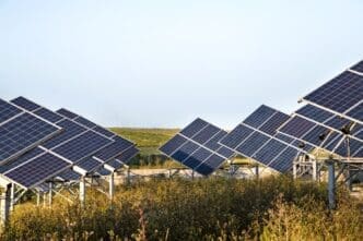 A solar power station's photovoltaic panels set against a natural background