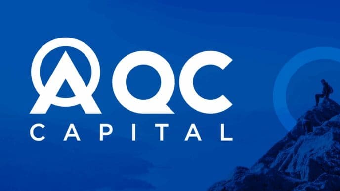 The logo for AQC Capital, featuring the letters 'AQC CAPITAL' in white with an upward-pointing arrow integrated into the 'A'. It is set against a blue background with a silhouette of a person standing on a mountain peak.