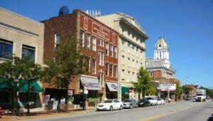 A street-level view of the business district in Indiana, Pennsylvania, showing the historic brick buildings, local storefronts, and classic American main street architecture along Philadelphia Street.