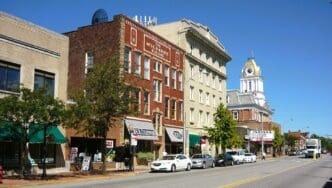 A street-level view of the business district in Indiana, Pennsylvania, showing the historic brick buildings, local storefronts, and classic American main street architecture along Philadelphia Street.