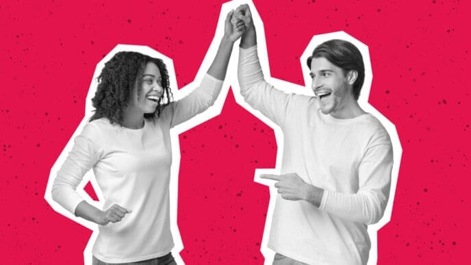 A stylized, black and white photo of an excited man and woman giving each other a high-five, presented with a white cutout border against a solid red background.