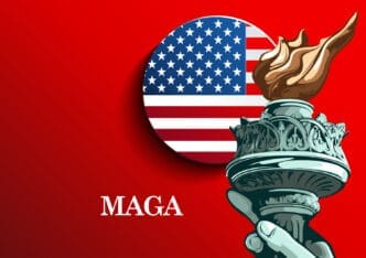 A political illustration showing the hand and torch of the Statue of Liberty in front of a circular American flag icon, with the acronym "MAGA" written in white on a red background.