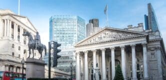 A low-angle shot looking up at the grand, historical facade of the Bank of England in London, emphasizing its classical architecture and imposing columns.