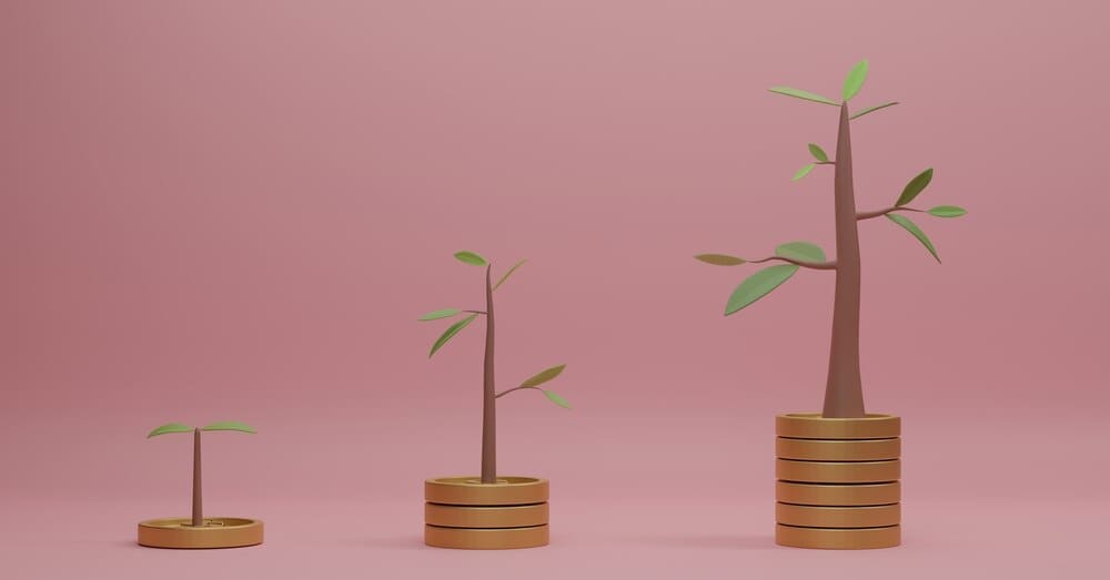 3D rendering of several stacks of coins with small trees growing on top, set against a pink backdrop.
