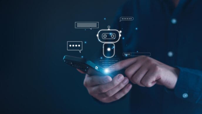 A person holding a smartphone with a glowing chatbot icon and chat bubbles floating above it, symbolizing AI interaction.