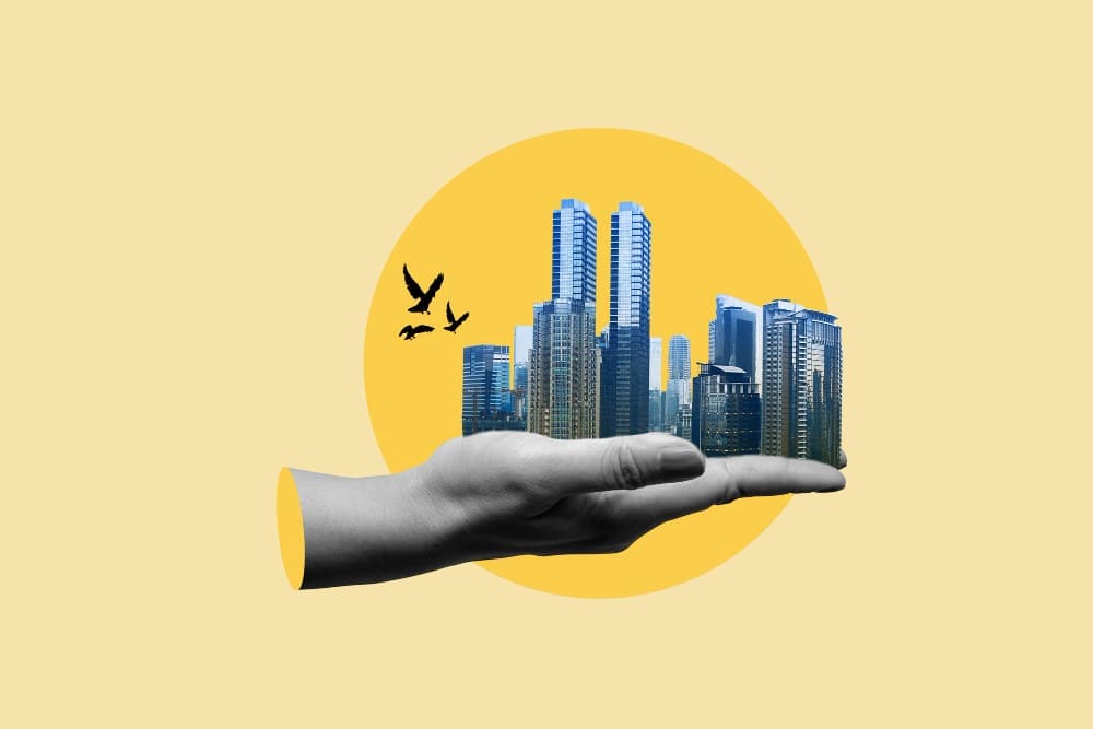 A grayscale hand holds a miniature cityscape of tall buildings, with three black bird silhouettes flying nearby, all against a golden-yellow circle on a light yellow background, symbolizing AI's influence in real estate.