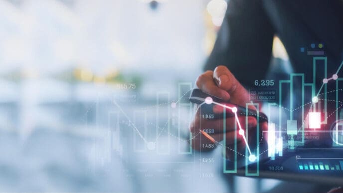 A person in a dark suit interacts with a holographic digital display showing various financial graphs, bar charts, and data, indicating analysis and problem-solving in a FinTech context.