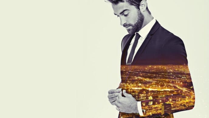 A double exposure image of a man in a suit, with a night cityscape superimposed onto his body, creating a conceptual representation of wealth, influence, or a deep connection to urban development.
