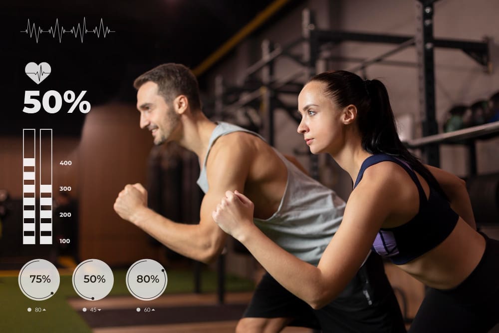 A man and a woman in athletic wear in a gym, with digital overlays indicating a heart rate of 50% and workout metrics.