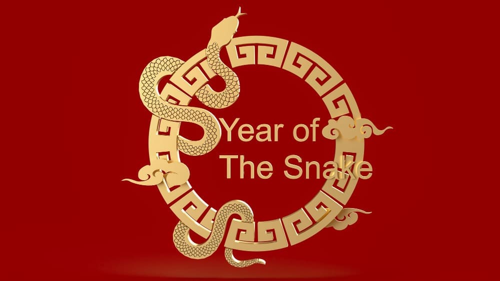 A 3D rendering of a golden snake coiled around an ornate circular golden frame that contains the text "Year of The Snake," all against a solid red background.