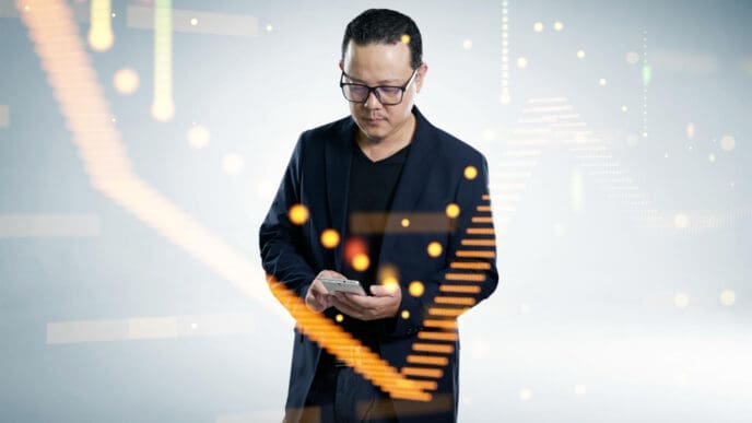 A man in a dark blazer and glasses looks down at his smartphone, surrounded by glowing orange and green digital data streams and abstract light patterns, on a white background.
