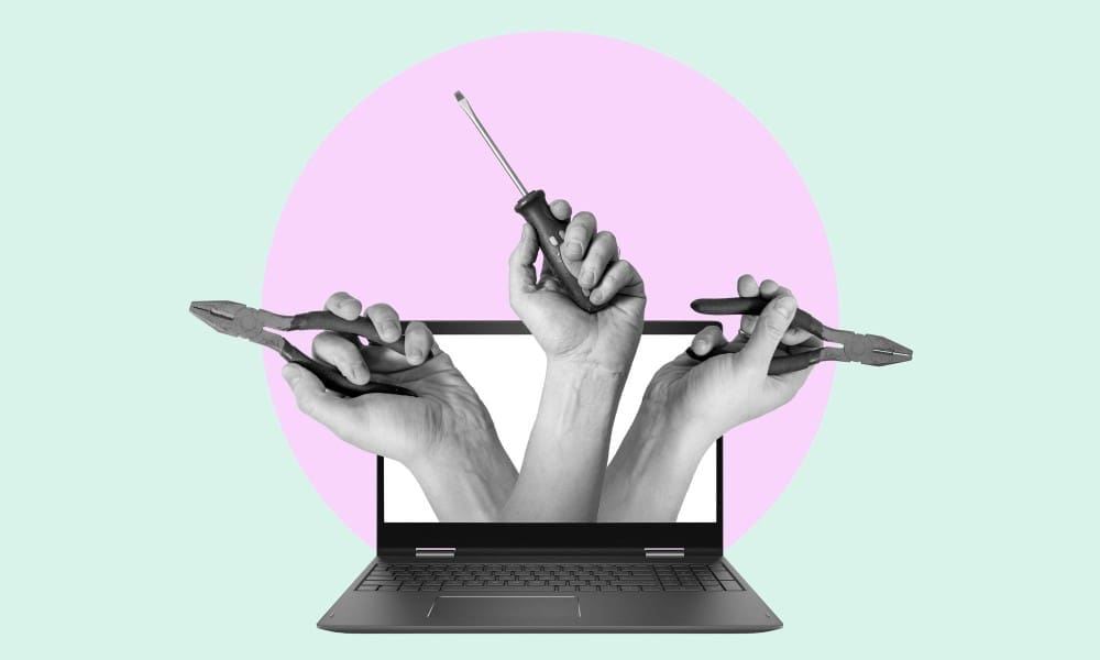 A digital collage featuring a laptop with three grayscale hands emerging from its screen, holding a screwdriver and two pairs of pliers, set against a light green and pink circular background.