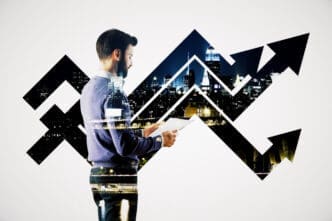 A double exposure image of a man holding papers, superimposed with an upward-trending arrow and a cityscape at night, symbolizing financial growth.
