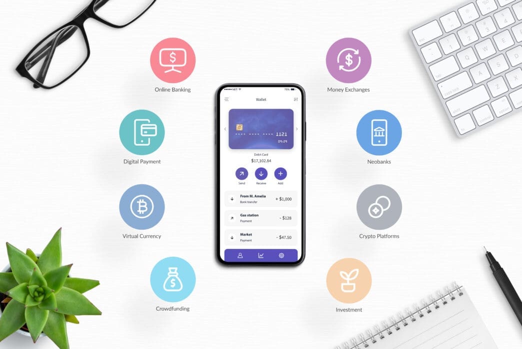 A smartphone displaying a digital wallet app is centered on a white desk, surrounded by eight circular icons representing various fintech services like online banking, virtual currency, neobanks, money exchanges, and investment platforms.