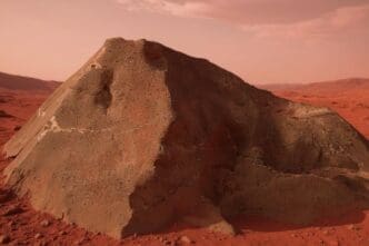 A large, reddish-brown, angular rock, identified as the Martian meteorite NWA 16788, rests on a desolate, red-hued planetary landscape under a hazy sky.