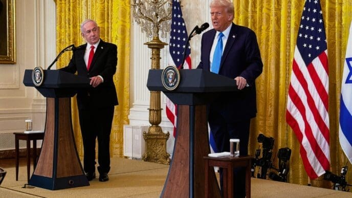 President Donald Trump and Prime Minister Benjamin Netanyahu stand at podiums with presidential and governmental seals, speaking to a press conference, flanked by American and Israeli flags in a room with golden curtains.