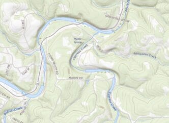 A topographic map showing a hilly, wooded area in Texas with a winding river (Cypress Creek), various roads, and elevation contours, highlighting the location of a summer camp area near Mystic Springs.