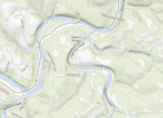 A topographic map showing a hilly, wooded area in Texas with a winding river (Cypress Creek), various roads, and elevation contours, highlighting the location of a summer camp area near Mystic Springs.