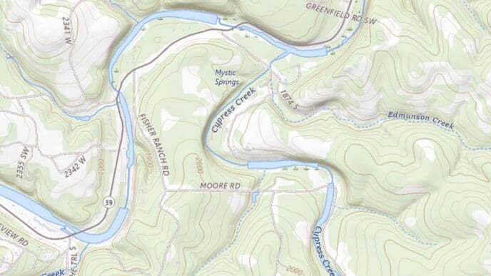 A topographic map showing a hilly, wooded area in Texas with a winding river (Cypress Creek), various roads, and elevation contours, highlighting the location of a summer camp area near Mystic Springs.