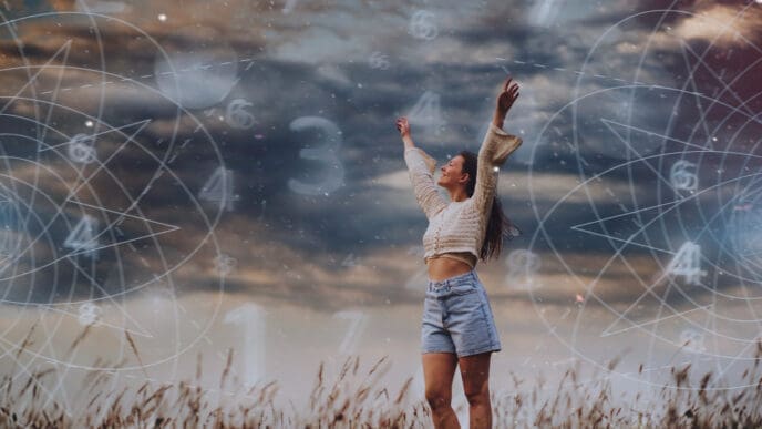 A woman stands in a field with arms raised to the sky, surrounded by swirling lines and numbers representing astrological or spiritual concepts, under a dramatic cloudy sky.
