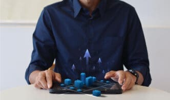 A person holding a tablet displaying a 3D city model with upward arrows and dollar signs, symbolizing AI investment and growth.