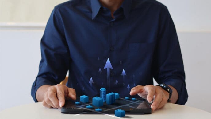 A person holding a tablet displaying a 3D city model with upward arrows and dollar signs, symbolizing AI investment and growth.