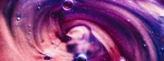 Abstract banner with swirling paint splashes, water drops, and a gel-like texture.