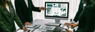 A team of analysts uses business intelligence fintech to analyze a financial report.