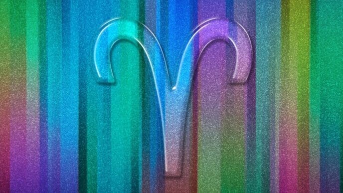 A colorful background features the Aries zodiac sign.