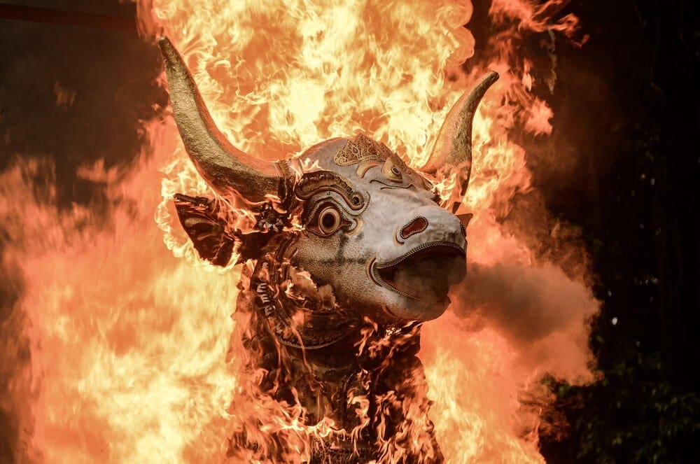 A photograph depicts elements of Balinese culture, possibly including traditional clothing, architecture, or ceremonies.