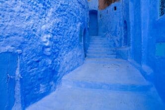 A street of blue buildings and houses in the city of Chefchaouen, Morocco.