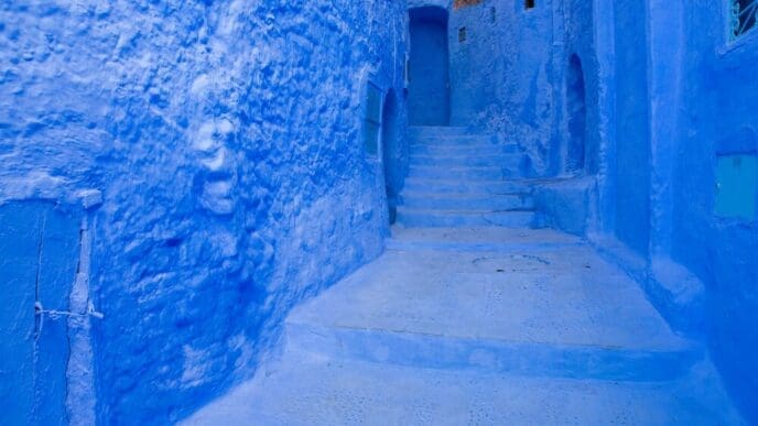 A street of blue buildings and houses in the city of Chefchaouen, Morocco.